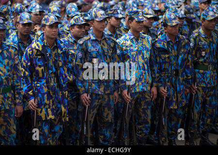 Dhaka, Bangladesh. 15th Dec, 2014. Bangladesh police preparing themselves  in front of National Martyrs' Memorial where thousands of people will gather on the Victory Day to pay homage to the Liberation War martyrs. Jatiyo Sriti Shoudho or National Martyrs' Memorial is the national monument of Bangladesh is the symbol in the memory of the valour and the sacrifice of all those who gave their lives in the Bangladesh Liberation War of 1971, which brought independence and separated Bangladesh from Pakistan. The monument is located in Savar, about 35 km north-west of the capital, Dhaka. © zakir hos Stock Photo