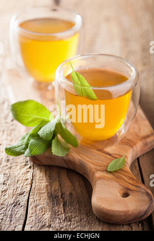 herbal sage tea with green leaves in glass cups Stock Photo