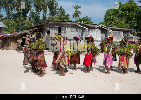 Melanesia, New Guinea, Papua New Guinea. Small island of Ali off the coast of mainland PNG. Local villagers dancing in costume. Stock Photo