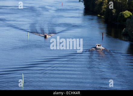 Motorboats / skiffs going opposite directions at passage at river Leppävirta , Finland Stock Photo