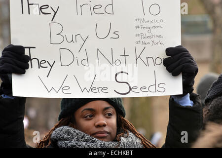 New York City, USA. 13th Dec, 2014. Robin Hancock holds a sign before the start of the Millions March in New York's Washington Square Park, Saturday, Dec.13, 2014.  Credit:  Shoun Hill/Alamy Live News Stock Photo