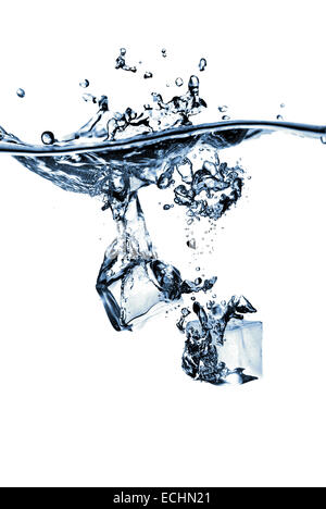 ice cubes dropped into water with splash isolated on white Stock Photo