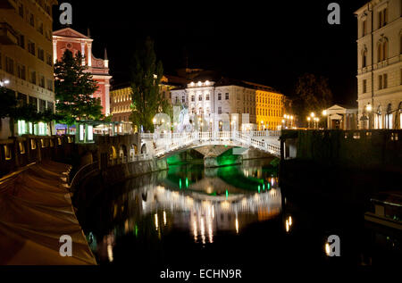 Ljubljana city at night, Slovenia. View to Triple Bridge over Ljubljanica river and Franciscan Church Stock Photo