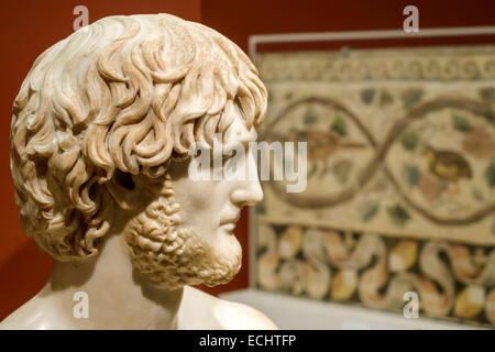 Marble bust of a man. Culture: Roman. Dimensions: H. 7 3/4 in. (19.7 cm).  Date: 3rd century A.D.. Beardless man with cloak on left shoulder. The  barely articulated hairstyle is divided into
