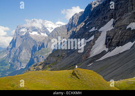 Hikers on the Eiger Trail, running along the base of the Eiger North Face Stock Photo