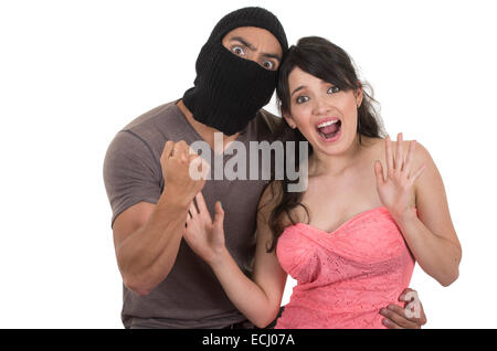 male masked thief holding young girl Stock Photo