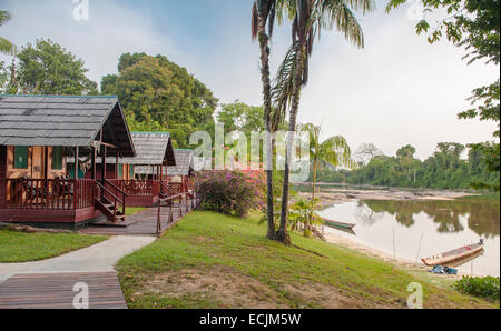 Eco-friendly Danpaati Lodge on the banks of Suriname River with a canoe moored, Upper Suriname, South America Stock Photo