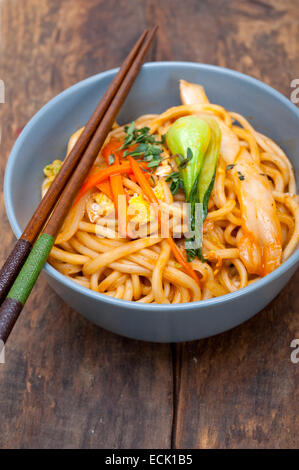 hand pulled stretched Chinese ramen noodles on a bowl with chopstick Stock Photo