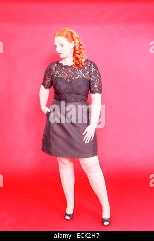 Portrait of overweight woman with long curly hair wearing beige