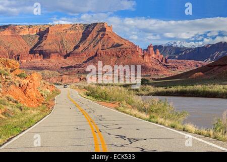 United States, Utah, Colorado Plateau, State Route 128 (SR-128) designated the Upper Colorado River Scenic Byway, the Colorado river with the Fisher Towers rock formations and the La Sal mountains in the background near Moab Stock Photo