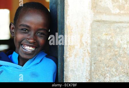 Kenya, Laikipia, Il Ngwesi, portrait of smiling schoolboy Stock Photo