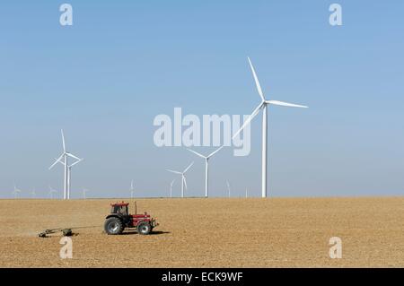 France, Ardennes, Fraillicourt, wind turbines field in the south of the city, tracor in front of the wind turbines and coming from the left Stock Photo