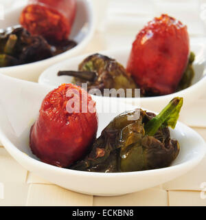 some little bowls with spanish fried chorizo and Padron peppers served as tapas Stock Photo