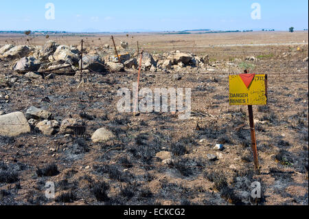 A warning sign with 'Danger Mines' written on it at a mine field on the Golan Heights in Israel Stock Photo