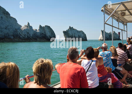 Horizontal view of people on a tour boat taking photographs of the Needles in the Isle of Wight. Stock Photo