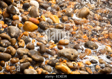 Horizontal close up of small colourful pebbles on the beach in the Isle of Wight. Stock Photo