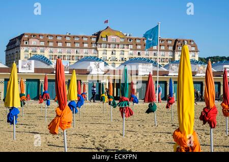 France, Calvados, Pays d'Auge, Deauville, the beach and its 600 parasols, the luxury hotel Royal Barriere in the background Stock Photo