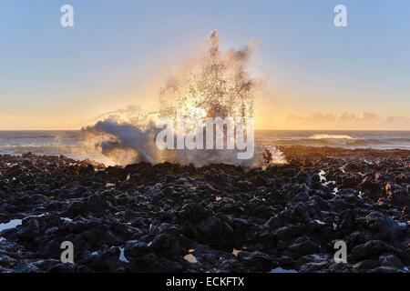 France, Reunion Island, Etang Sale les Bains, marine natural landscape horizontal view of coastline swell at sunset Stock Photo