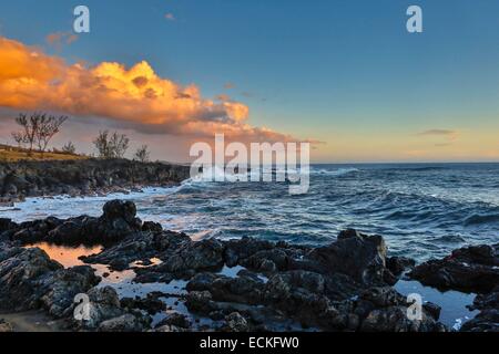 France, Reunion Island, Etang Sale les Bains, marine natural landscape horizontal view of coastline swell at sunset Stock Photo