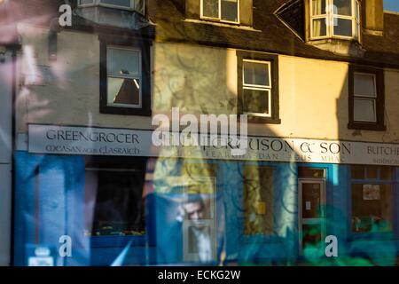 United Kingdom, Scotland, Argyll and Bute, Lochgilphead, cityscape, reflection in a window of a pharmacy and view of the house across the street at sunrise Stock Photo