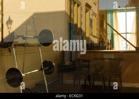 United Kingdom, Scotland, Argyll and Bute, Lochgilphead, cityscape, reflection in a window of a room of municipal cultural activity at sunrise Stock Photo