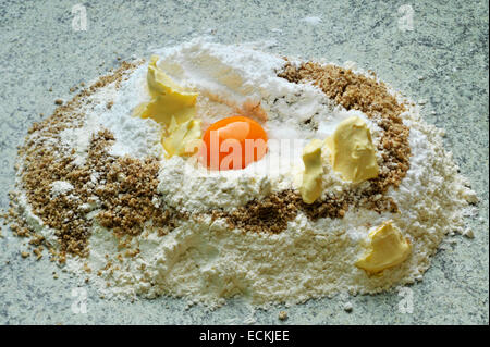 yolk,flour,butter,granulated sugar on the work surface Stock Photo