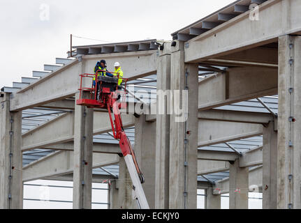 Sofia, Bulgaria - November 24, 2014: An engineer and a manual worker are working on a construction site of a new waste plant nea Stock Photo