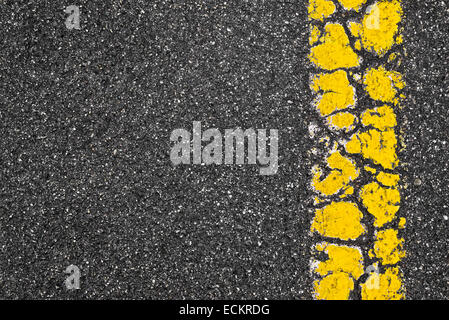 Yellow Grunge Road Marking Stripe On Dark Asphalt Background Stock Photo