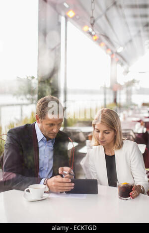 Business people using digital tablet in cafe Stock Photo