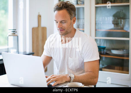 Man working on laptop at home Stock Photo