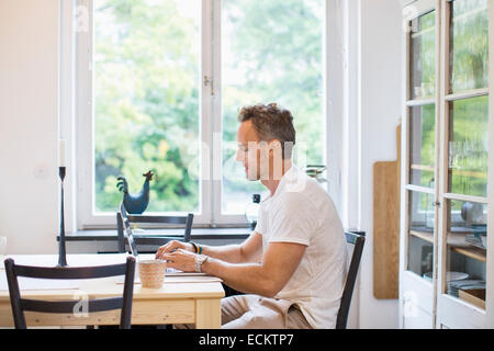 Man using laptop at home Stock Photo