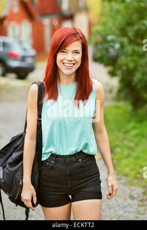 Portrait of happy mid adult woman walking on street Stock Photo