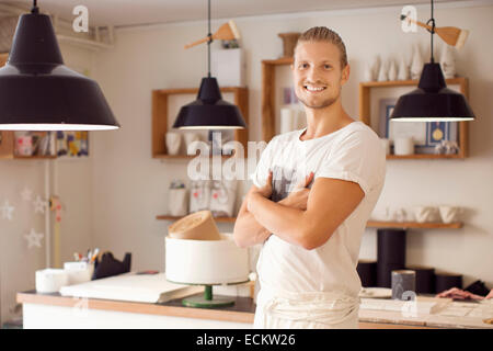 Portrait of smiling craftsperson standing with arms crossed in crockery workshop Stock Photo