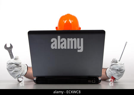Mechanic is repairing a laptop, isolated on white. Stock Photo