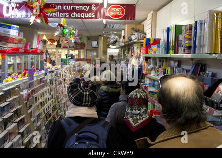 Wimbledon, London, UK. 16th Dec, 2014. Longer queues at the Post Office as people try to get the Christmas post deadline. The longer queues is partly caused by the closure of thousands of Post Office branches across the United Kingdom Credit:  amer ghazzal/Alamy Live News Stock Photo
