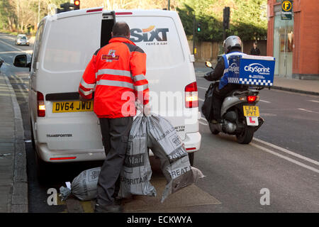Wimbledon, London, UK. 16th Dec, 2014. Bags containing Christmas post are placed into a van. Longer queues at the Post Office as people try to get the Christmas post deadline. The longer queues is partly caused by the closure of thousands of Post Office branches across the United Kingdom Credit:  amer ghazzal/Alamy Live News Stock Photo