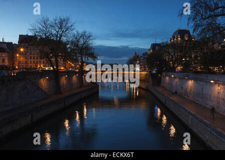 View of Paris and the Seine River at dusk from 'Pont au Double', near Notre Dame Cathedral. Paris, Ile de France, France, Stock Photo