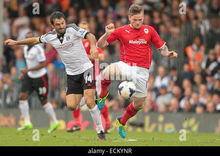 LONDON, GREAT BRITAIN - SEPTEMBER 28 Aron Gunnarsson (#17 Cardiff) and Giorgo Karagounis (#14 Fulham) fight for the ball at a Pr Stock Photo