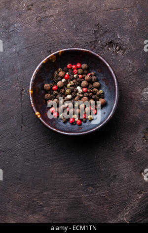 Multicolored peppers peas on dark background Stock Photo