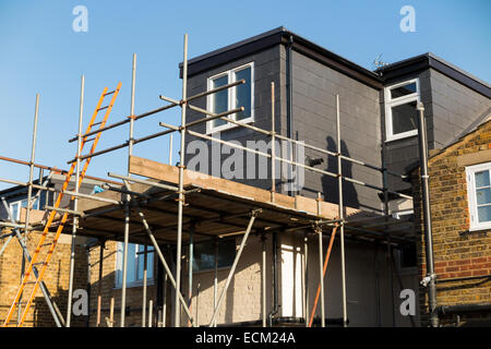 Scaffolding to a newly completed dormer / dormers / dormas / dorm on the roof on a Victorian terraced house in Twickenham. UK Stock Photo