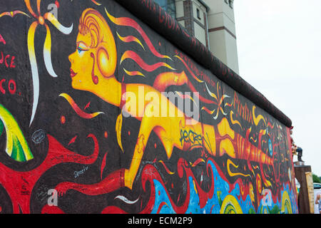 Artwork on a section of the Berlin Wall at Berlin's East Side Gallery. Stock Photo