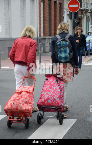 Senior and mature women strolling with shopping bags in city Stock ...