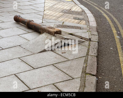 Pedestrian protecting cast iron pavement bollard knocked over by a truck in the centre of Bristol. 16th December 2014 Stock Photo