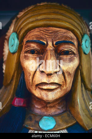 A brightly painted likeness of an American Indian stands outside of a tobacco store. Stock Photo