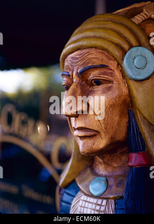 A brightly painted likeness of an American Indian stands outside of a tobacco store. Stock Photo