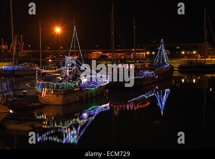 Ramsgate, Kent, UK. 16th December, 2014. Approximately twenty boats in Ramsgate Harbour are displaying Christmas Lights in a competition organised by the Royal Temple Yacht Club. Credit:  Paul Martin/Alamy Live News Stock Photo