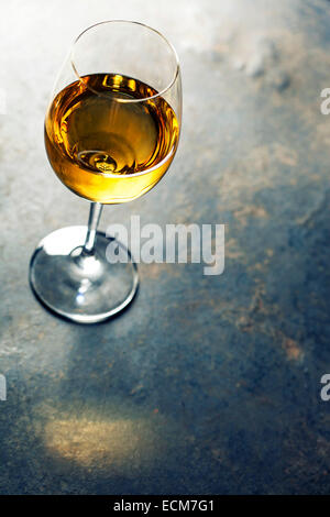 Glass of white wine on dark background Stock Photo