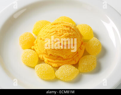 Scoop of yellow ice cream with gelatin-based candy Stock Photo