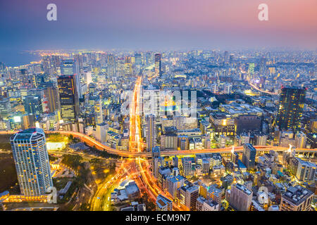 Tokyo, Japan cityscape at dusk above highway junction.