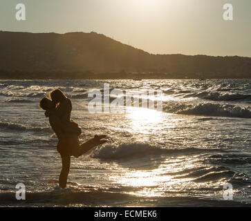 Young couple on the beach kissing, Corsica, France Stock Photo